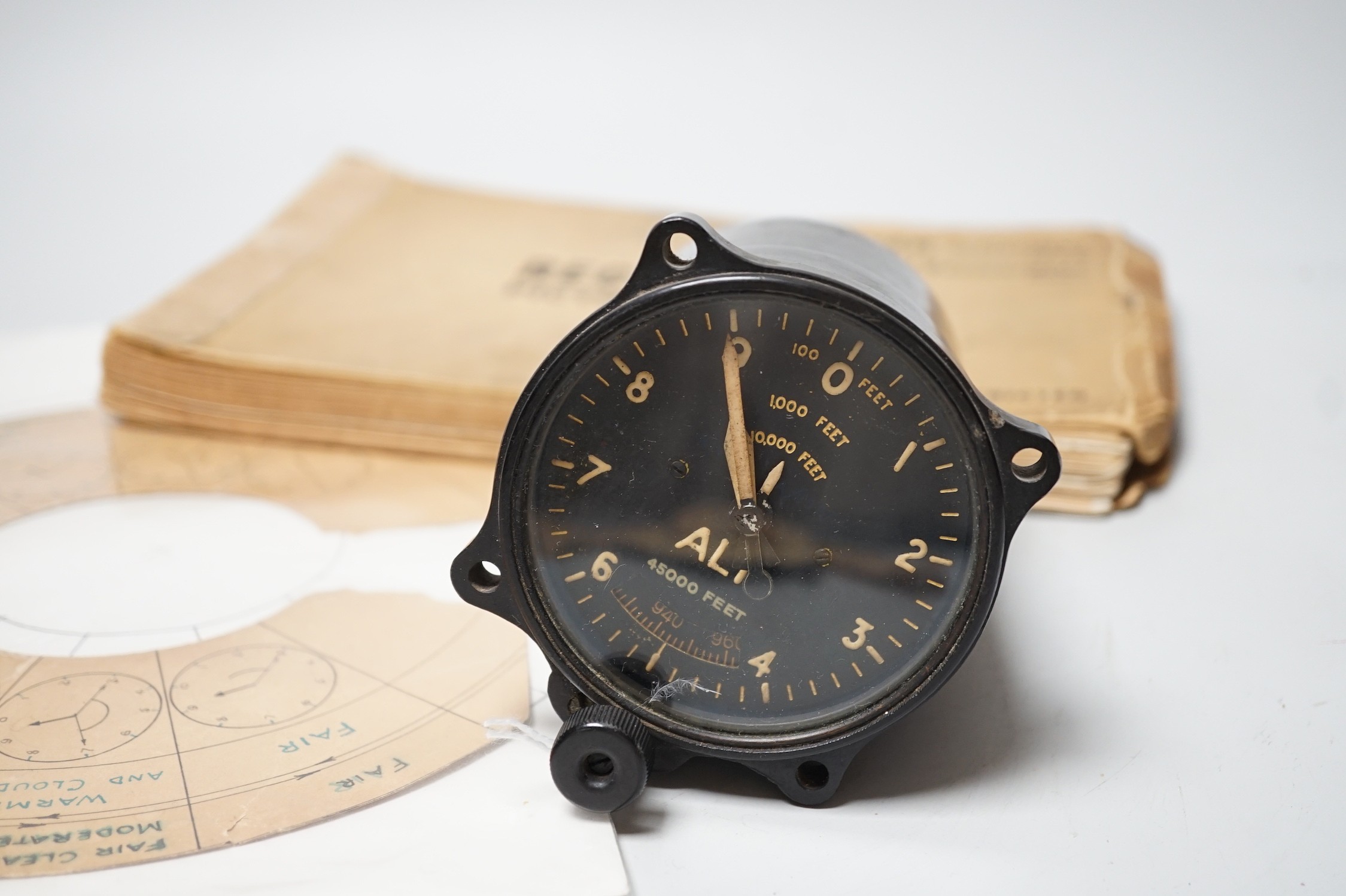 A WWII Air Ministry altimeter model XIV B and a War & Navy Department aircraft recognition pictorial manual